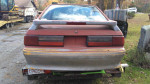 Rear view of a red 1987 Mustang GT parts car with minor rust, ideal for drag racing projects.