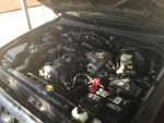 Engine compartment of Tacoma Pickup truck, showcasing well-maintained parts and fluids.