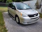2005 Toyota Sienna in silver color with 61,000 miles, parked on a driveway, showcasing its pristine exterior.