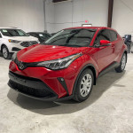 Front view of a 2020 Toyota C-HR LE FWD in red, showcasing its sleek design and spacious interior.