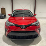 Front view of a 2020 Toyota C-HR LE Sport Utility in red color with a sleek design and clean title.
