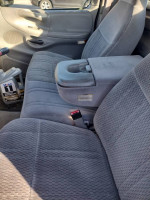 Interior view of a Ford F250 truck showing clean seats and center console, ready for sale despite engine issues.