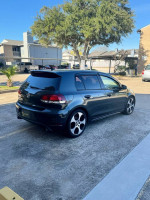 Volkswagen Jetta GTI in a parking lot, showcasing alloy wheels and clean exterior, ready for reasonable offers.