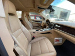 Interior view of a 2010 Porsche Panamera S showing beige leather seats and dashboard.