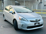 2012 Toyota Prius V Three in silver color, showcasing its clean design and features like alloy wheels and navigation.