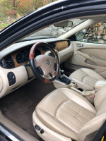 Interior view of a 2003 Jaguar X-Type with leather seats and wood accents