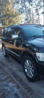 2008 Infiniti QX56 SUV in black with chrome accents and a sunroof, ready for sale.