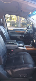 Interior view of a 2008 Infiniti QX56 with black leather seats and dashboard features.