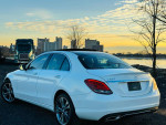 2016 Mercedes-Benz C-Class C 300 4MATIC in white, parked with scenic background at sunset.