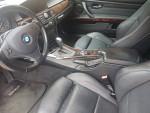 2011 BMW 328I convertible interior with black leather seats and wood trim, showing steering wheel and gear shift.
