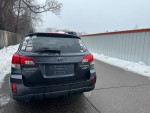 2011 Subaru Outback AWD parked, reliable vehicle with low mileage, well-maintained, shown on a snowy street.