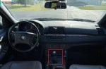 Interior view of a 2006 BMW X5 3.0i showing the manual transmission and dashboard with gauges.