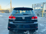Rear view of a 2013 Volkswagen GTI in black, showcasing its clean design and GTI badge.