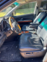 Interior view of a 2008 Lexus RX350, featuring leather heated seats and wood trim.