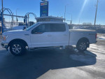 2018 Ford F-150 XLT 4WD parked at a car wash, featuring new tires and a spacious bed for utility.