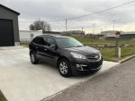 2015 Chevrolet Traverse LT AWD parked outside, showcasing modern design and winter-ready features.