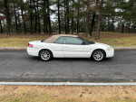 2006 Chrysler Sebring Touring FWD in white, parked in a scenic area, showcasing its convertible top