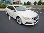 2011 Volkswagen CC in white, parked, showcasing its sleek design and clean upholstery.