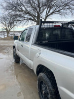 2005 Toyota Tacoma truck in silver with back rack, new tires, parked outdoors.