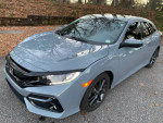 2021 Honda Civic EX in gray color with sunroof, parked on a leaf-covered street, showing excellent condition.