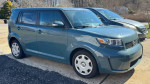 2010 Scion xB in teal color parked, featuring a salvaged title and recent tire replacements