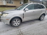 2009 Saturn VUE AWD parked on a snowy street, featuring clean front seats and minor exterior dings.