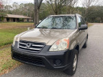 2006 Honda CR-V LX FWD parked on a street, well-maintained, 111,000 miles, ready for road trips.