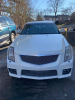 Front view of a white Cadillac CTS with a modified bumper, showing clean exterior and new tires.