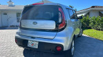 2017 Kia Soul in silver color parked outside a house, showcasing its rear design and clean condition.