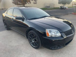 2011 Mitsubishi Galant in black with aftermarket wheels and modern features like backup camera and navigation.