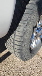 Close-up of a treaded tire on a 2007 Dodge Ram 3500 Mega Cab, showcasing its new condition.