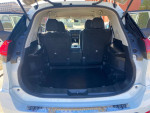 Interior view of the 2017 Nissan Rogue S FWD showing spacious trunk area and seating for five.