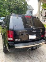 2008 Jeep Grand Cherokee Limited 4.7 AWD parked, showcasing its rear and 4x4 emblem.