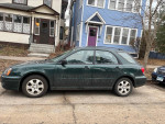 2004 Subaru Impreza station wagon parked on the street, showcasing its well-maintained condition.