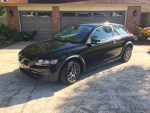 2010 Volvo C30 in black with Sparco wheels parked in driveway, showcasing its sleek design and good condition.