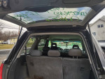 Interior view of a 2003 Honda Pilot showing spacious third row seating and features like a sunroof.