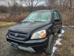 2003 Honda Pilot with black exterior parked in snowy landscape, features 4WD and leather seats.