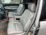 Interior view of a 2008 Lexus RX 350 with leather seats and wood trim, showcasing comfort and style.