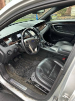 Interior view of a 2013 Ford Taurus Limited, featuring leather seats and dashboard details.