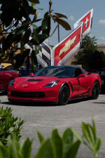 2015 Chevrolet Corvette Z06 in red, featuring sleek design and performance modifications, parked outdoors.