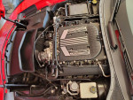 Engine bay of a 2015 Chevrolet Corvette Z06 showing performance parts and clean setup.
