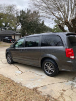 2017 Dodge Grand Caravan parked on driveway, showcasing its reliable design and spacious seating for families.