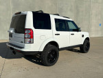 2013 Land Rover LR4 HSE Luxury in white, showcasing sleek design and off-road capabilities.