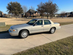 2008 Mercury Grand Marquis LS in silver parked on driveway, showcasing low mileage and clean exterior.
