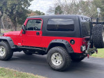 2005 Jeep LJ Unlimited 2-door, well-maintained, perfect for Jeep enthusiasts, parked on a driveway.
