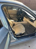 Interior view of 2007 BMW 328I with beige seats, showcasing its condition and features.