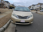 Front view of a well-maintained 2011 Toyota Sienna XLE with new LED lights parked in a residential area.