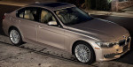 2015 BMW 328d with leather interior and metallic exterior, parked on street at night.