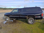 1995 Dodge 3500 dually truck parked by the roadside, showcasing new tires and bumpers.