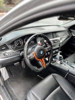 Interior view of a 2011 BMW 5 Series 528i, featuring a sleek dashboard and sporty steering wheel.